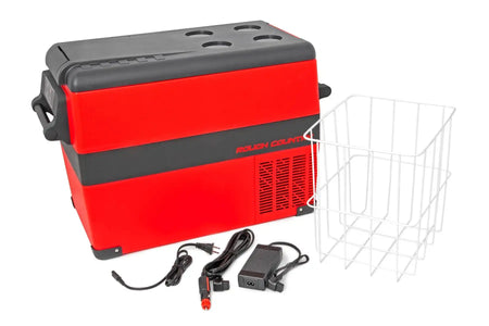 Red and black Rough Country 45L portable refrigerator/freezer with accessories including basket, power cables, and voltage converter.